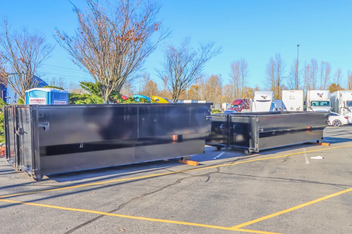 Professional dumpster rental service with roll-off container on residential driveway in Capitol View
